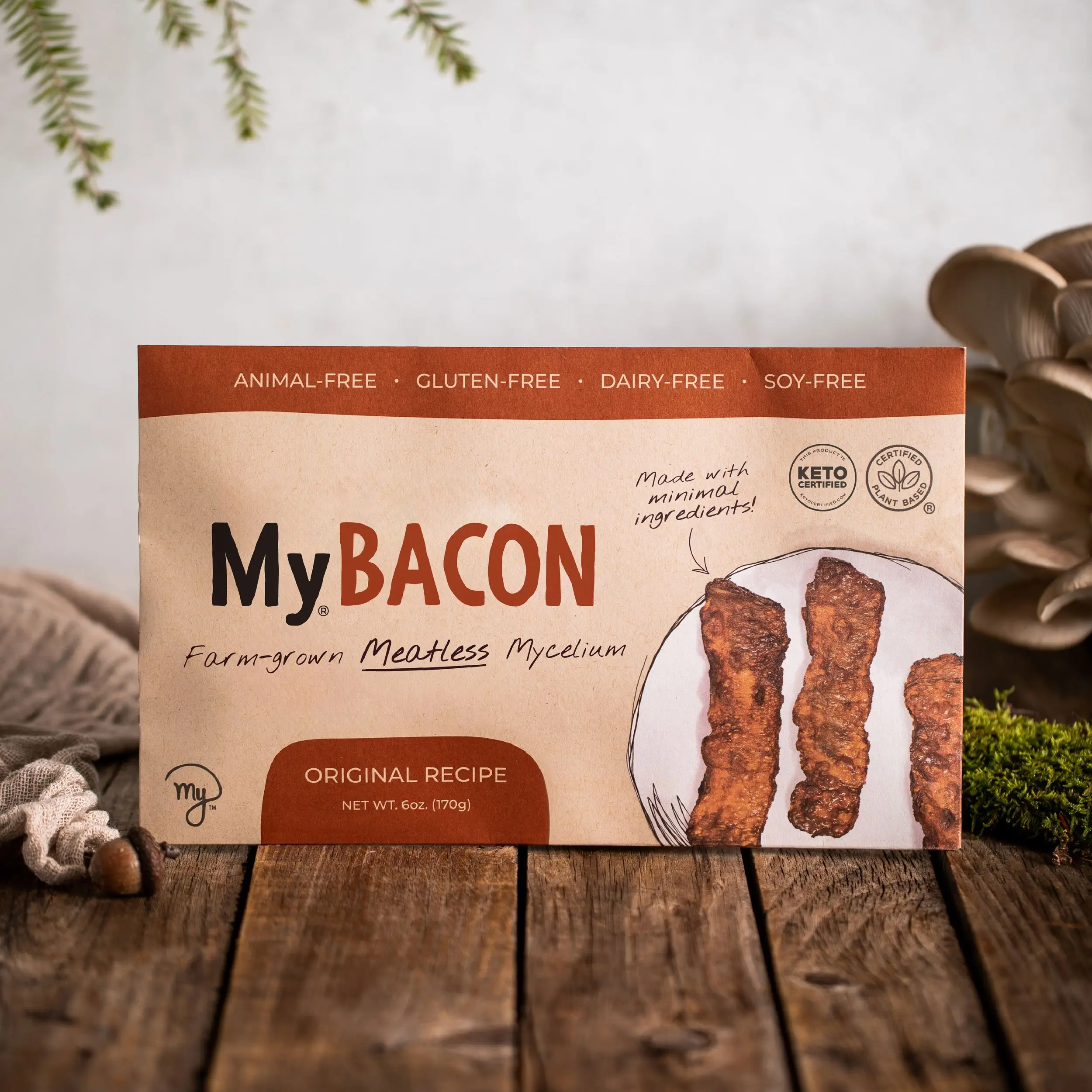 Photo of a pack of MyBacon on a wooden table with nature elements