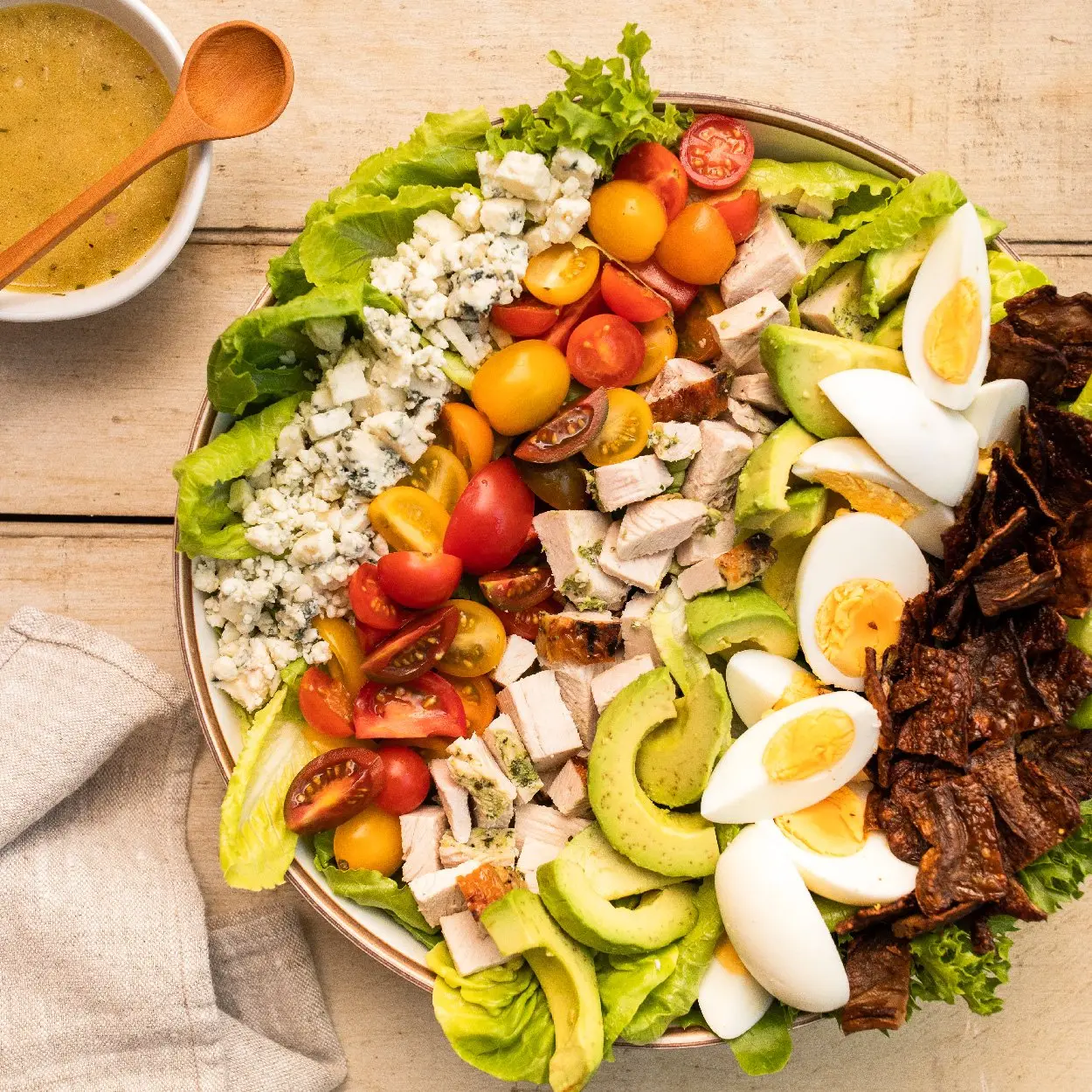 Beautiful cobb salad spread with 1-inch strips of MyBacon