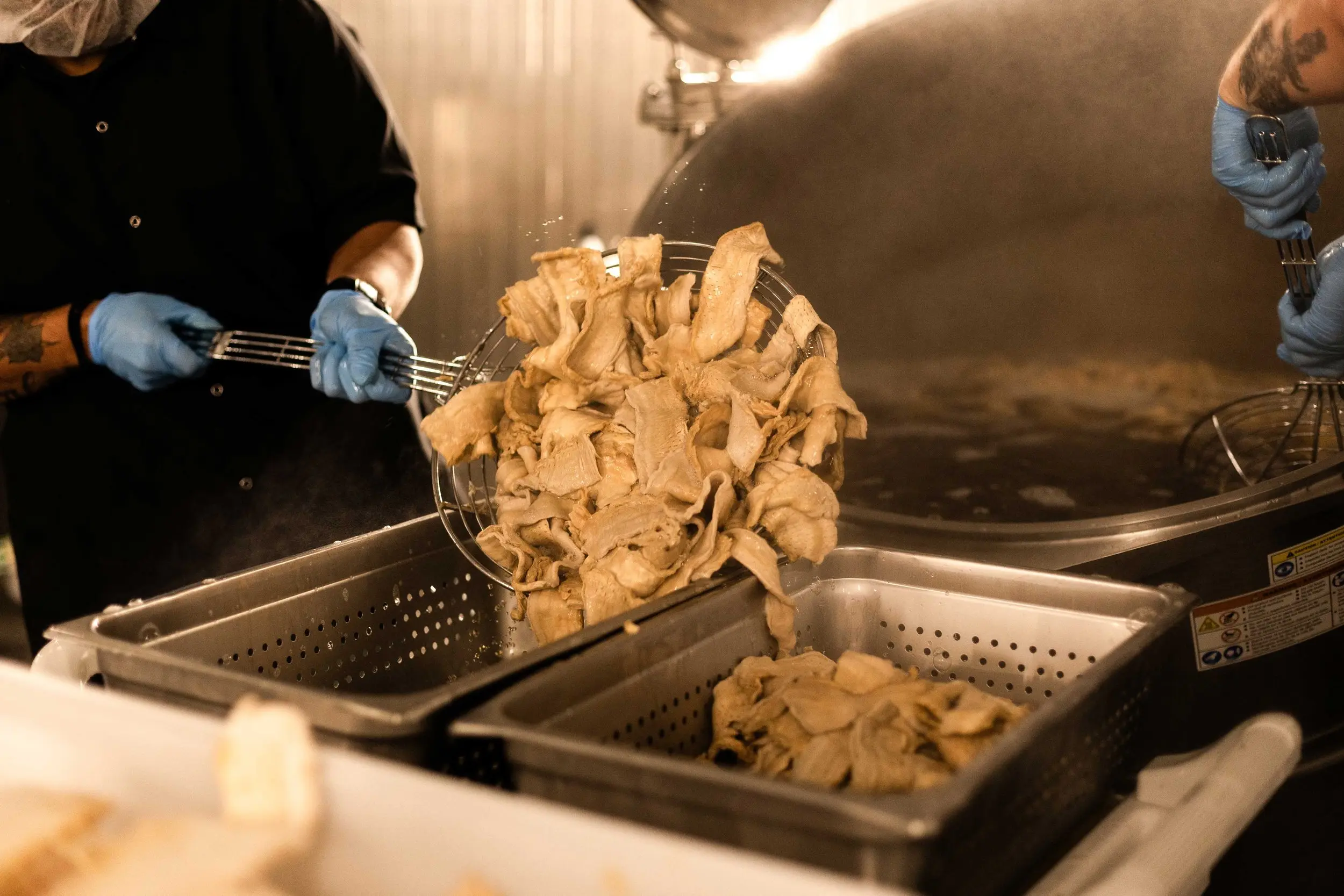 Photo of MyBacon slices being taken out of our brine bath