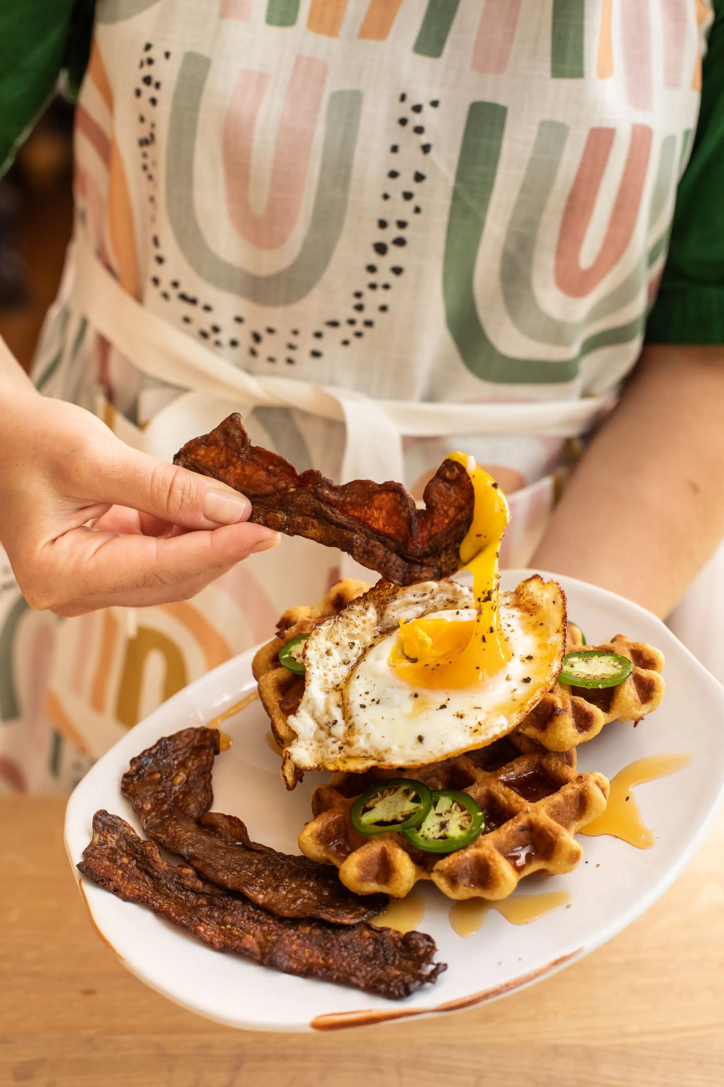 MyBacon being dipped in egg atop a waffle