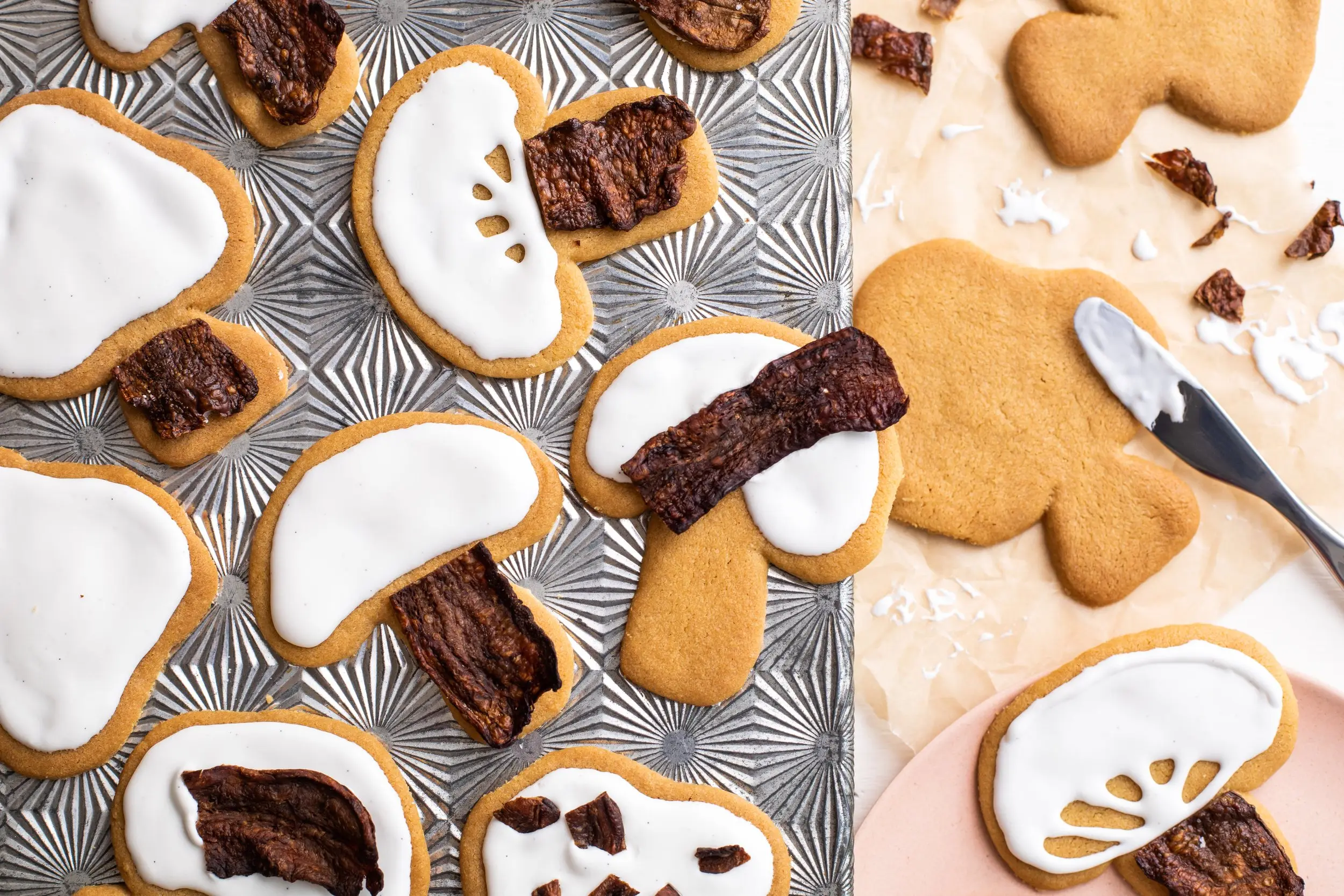 Mushroom-shaped sugar cookies with vanilla glaze and crumbled MyBacon pieces
