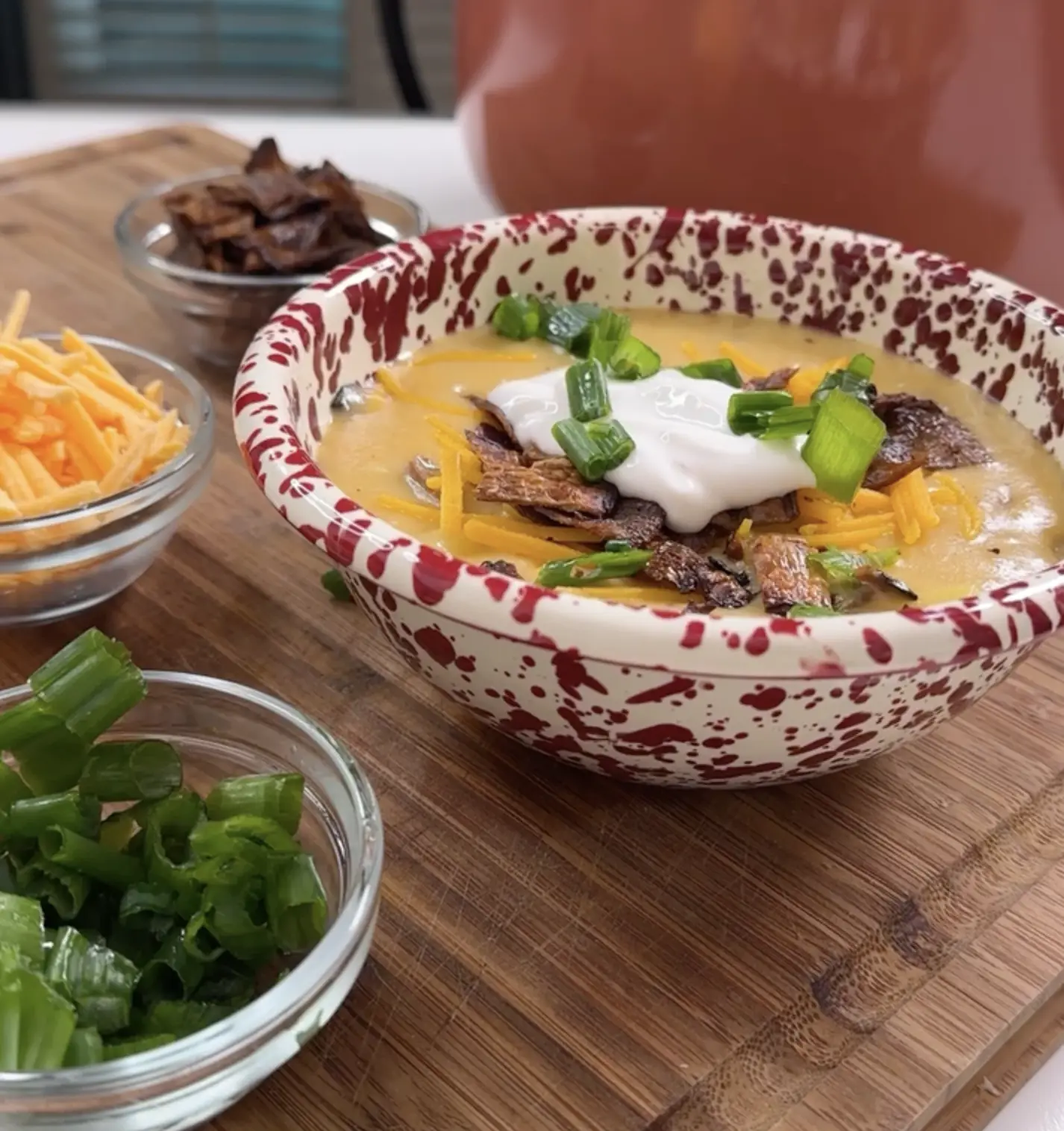 A bowl of MyBacon potato soup with toppings